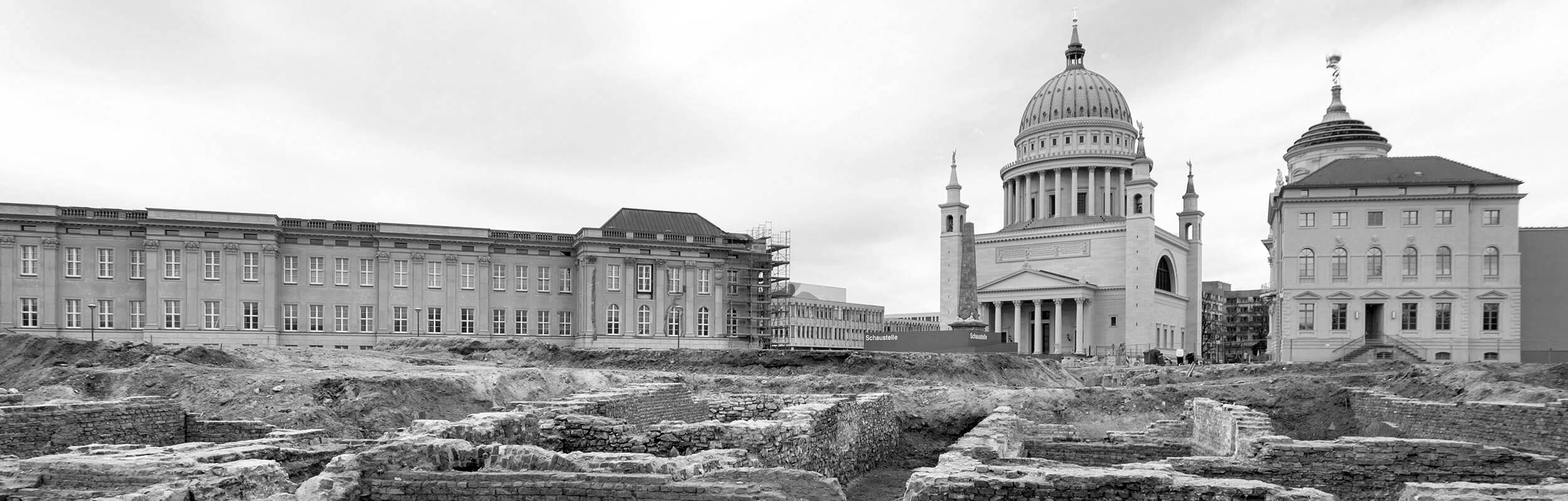 Foto: Im Vordergrund sind die Fundermente des ehemaligen Stadtschlosses am Havelufer zu sehen. Im Hintergrund stehen das neue Landsgebäude, die Nikolaikirche und das Museum.